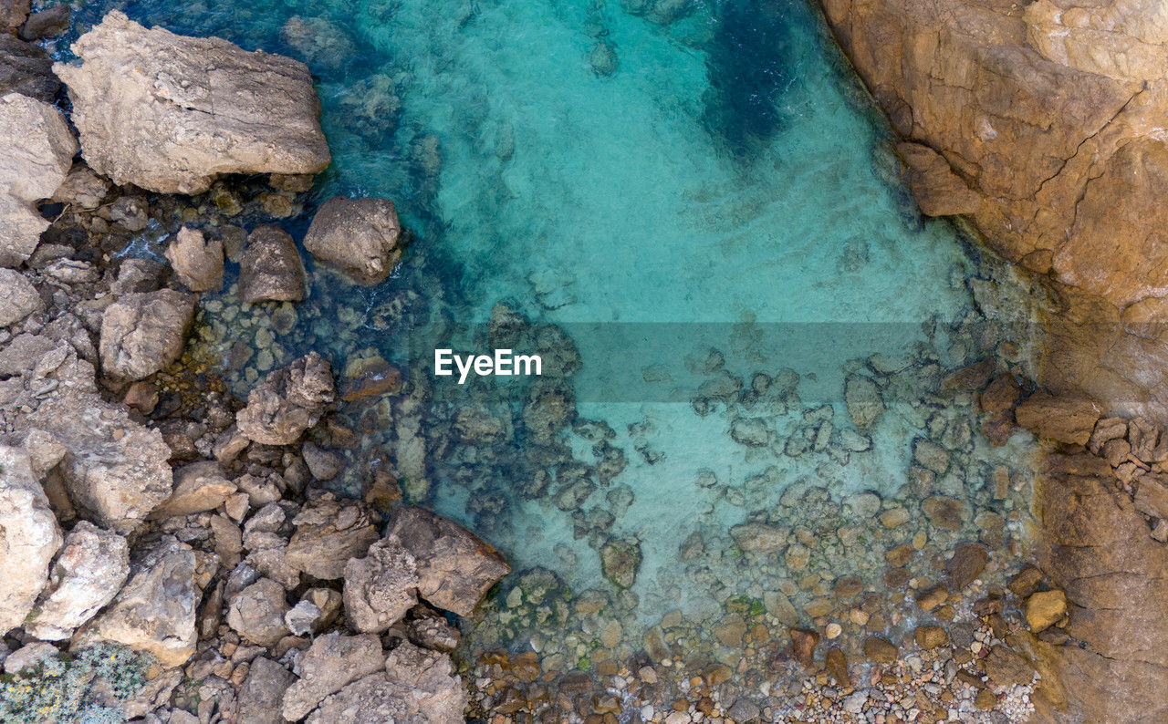 water, nature, high angle view, rock, beauty in nature, land, sea, no people, scenics - nature, day, turquoise colored, geology, beach, tranquility, environment, outdoors, reef, blue, physical geography, travel destinations, travel, rock formation, non-urban scene, transparent, landscape