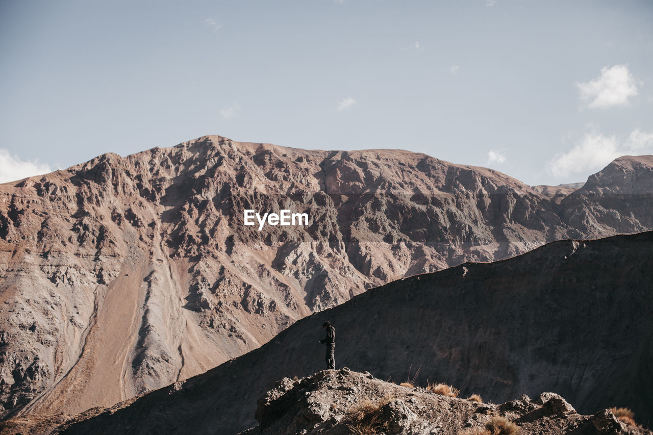 Scenic view of mountains against sky on sunny day