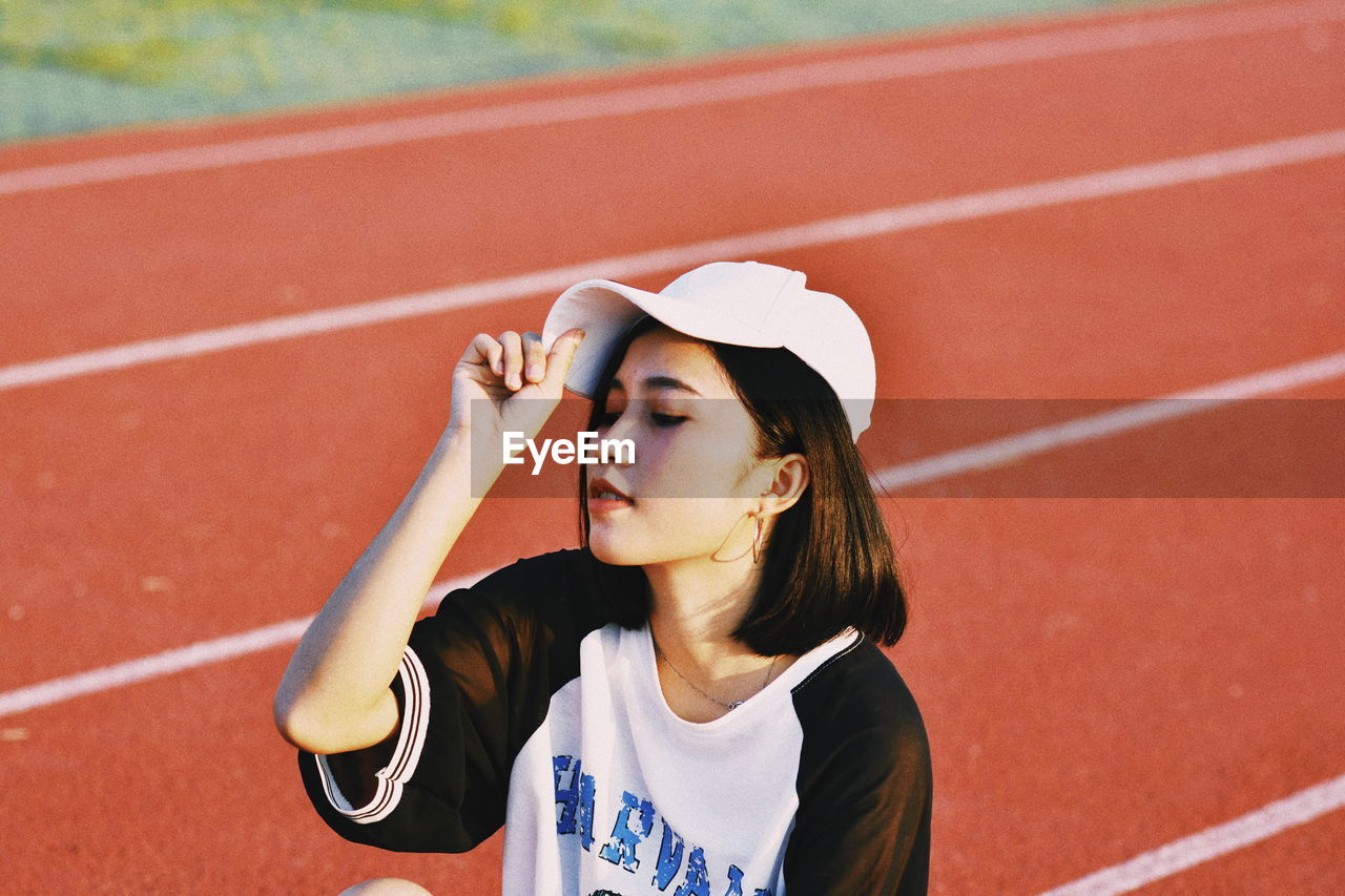 Young woman relaxing on running track