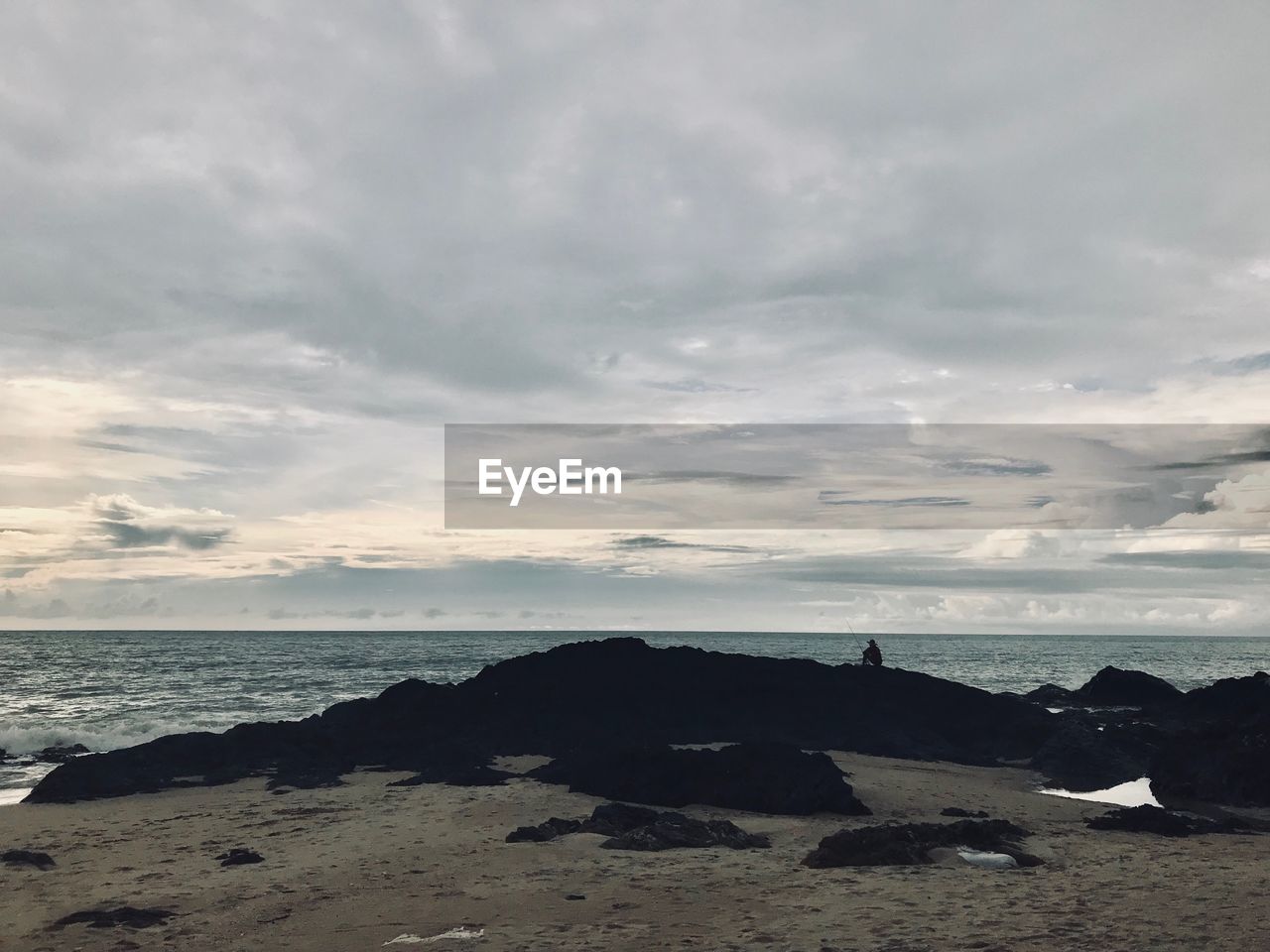 ROCKS ON SHORE AGAINST SKY