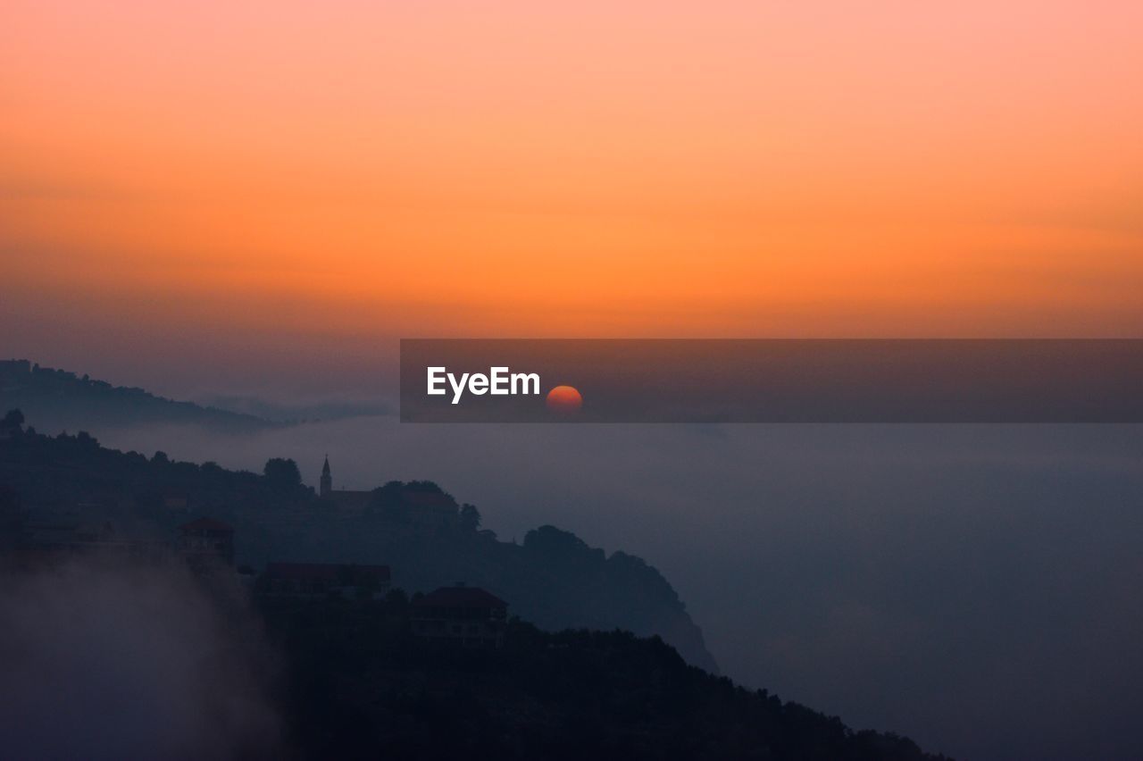 Scenic view of silhouette mountains against sky during sunset