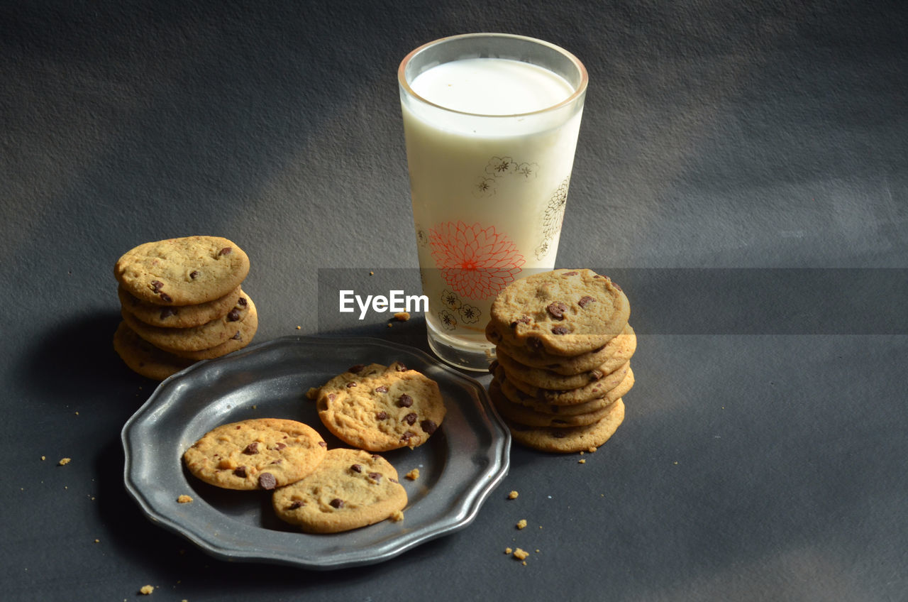 High angle view of chocolate chip cookies with milk