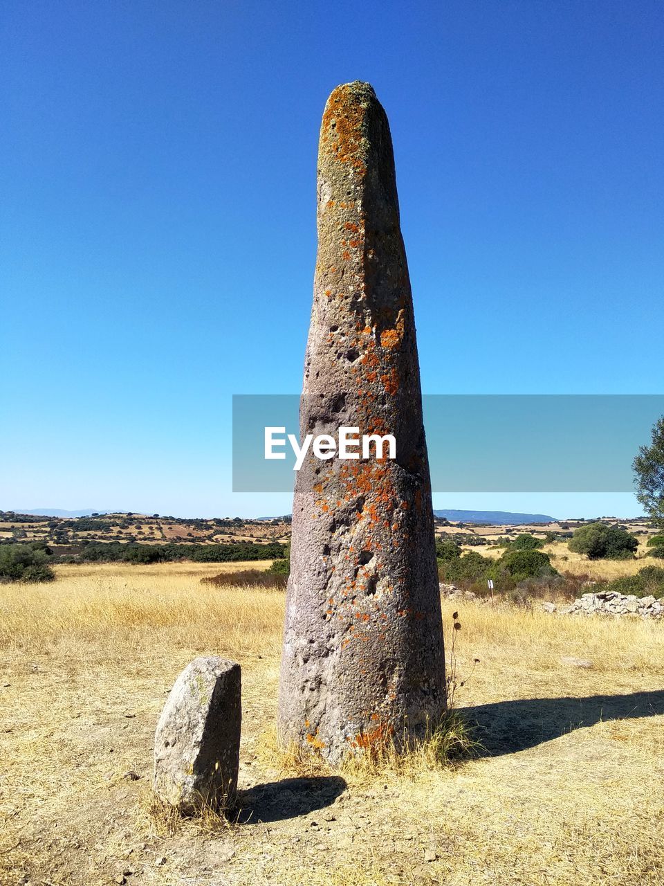 rock, sky, monolith, monument, clear sky, landscape, nature, land, sunlight, blue, history, ancient history, sunny, no people, the past, scenics - nature, ruins, environment, desert, travel destinations, day, megalith, landmark, geology, architecture, ancient, tranquil scene, tranquility, plant, travel, outdoors, sculpture, non-urban scene, old, old ruin, sea, natural environment, beauty in nature, temple, tree, semi-arid, sand