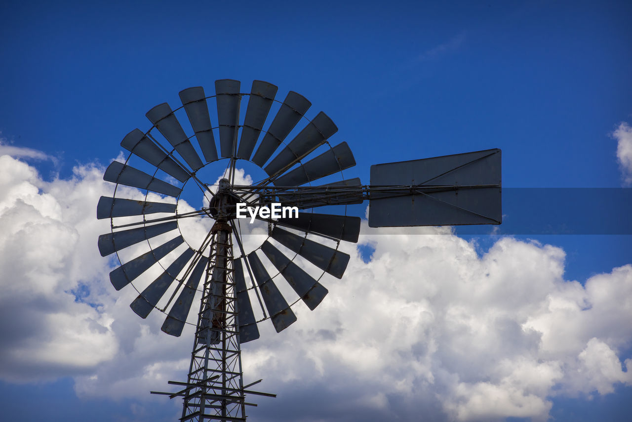 LOW ANGLE VIEW OF TRADITIONAL WINDMILL AGAINST SKY