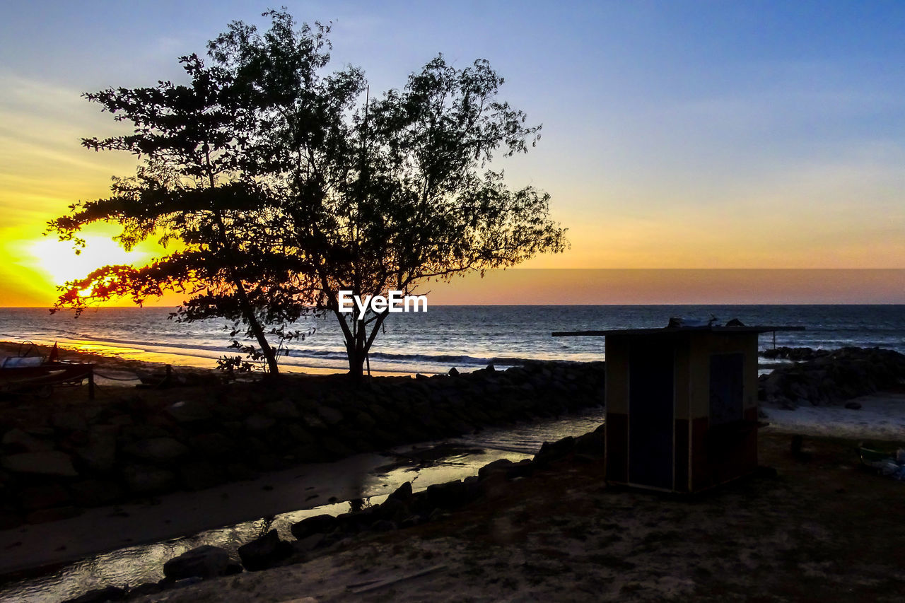 SCENIC VIEW OF BEACH DURING SUNSET