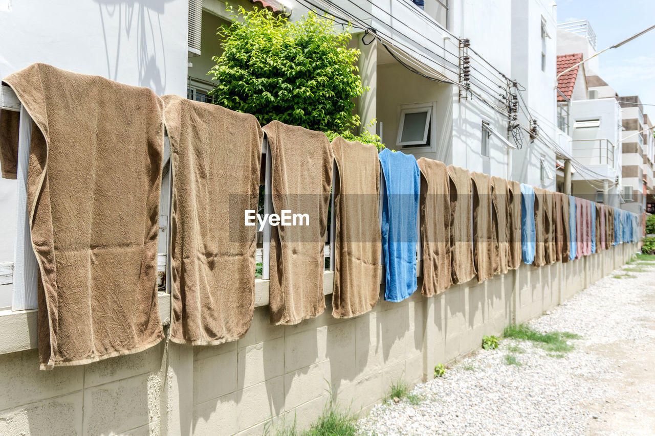 Clothes drying on wall by building