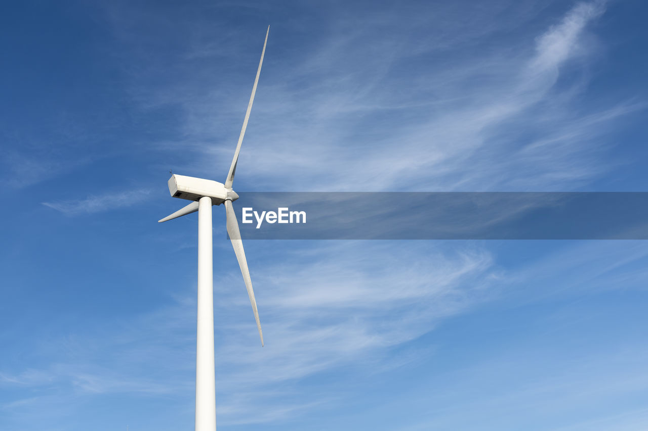 Wind turbine against blue sky