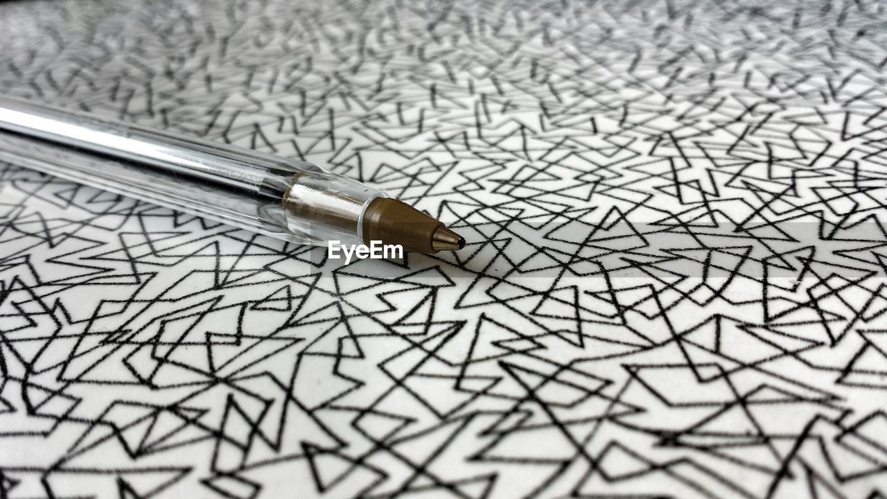 Close-up of pen on designed paper