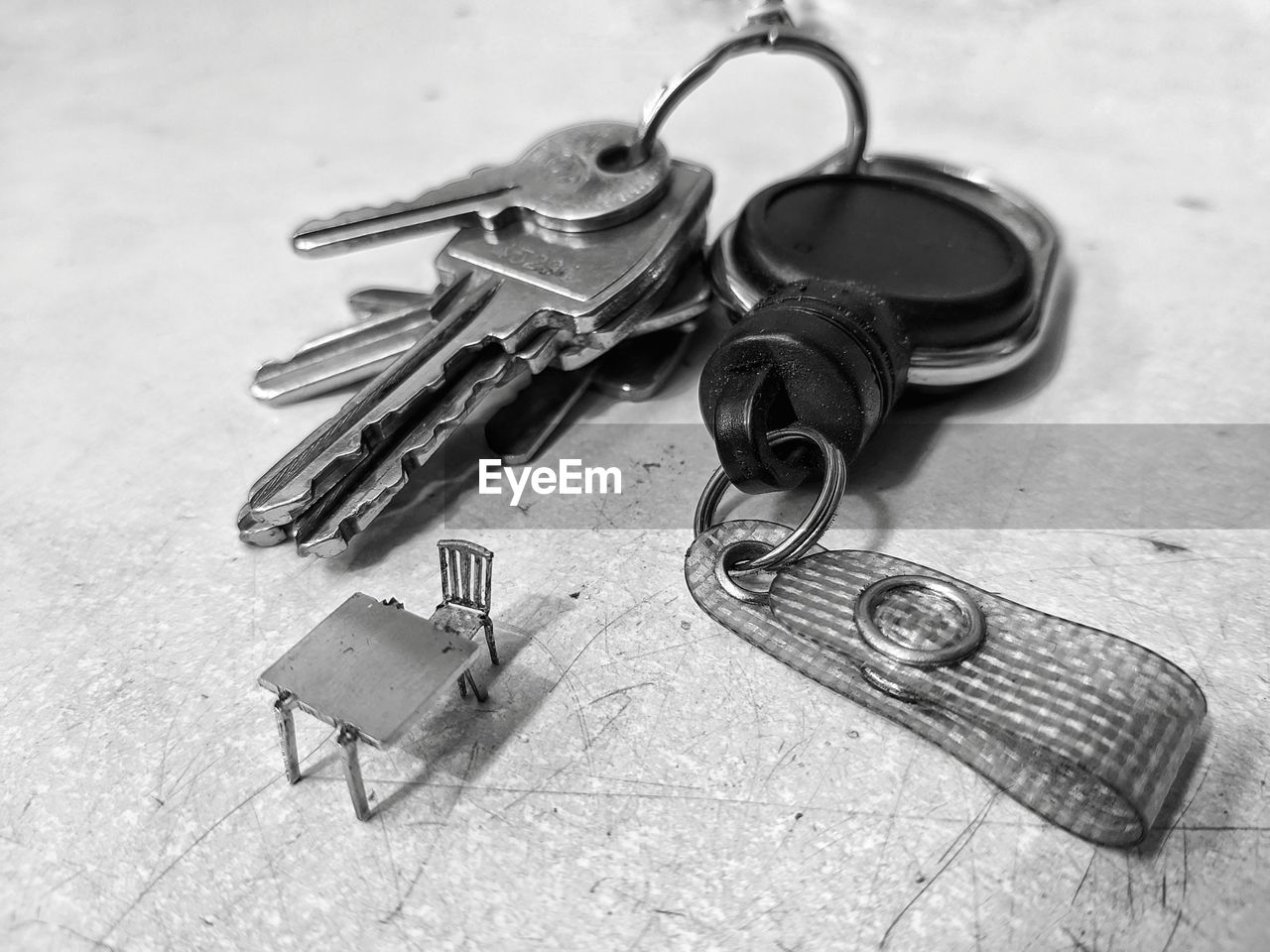 keychain, iron, metal, no people, high angle view, still life, fashion accessory, key, table, key ring, close-up, indoors