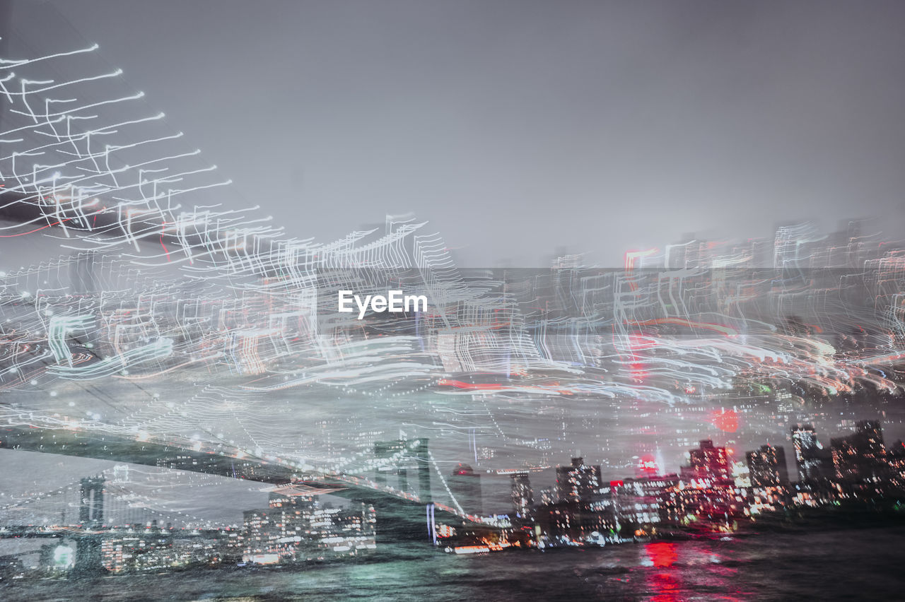 Double exposure of manhattan skyline, brooklyn bridge from dumbo park in new york city, usa