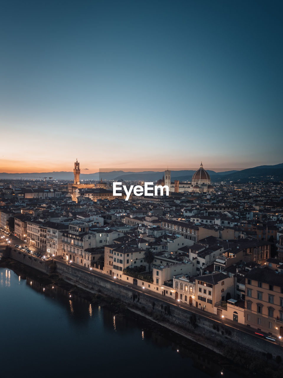 An aerial view of the illuminated city of florence at dusk and during blue hour