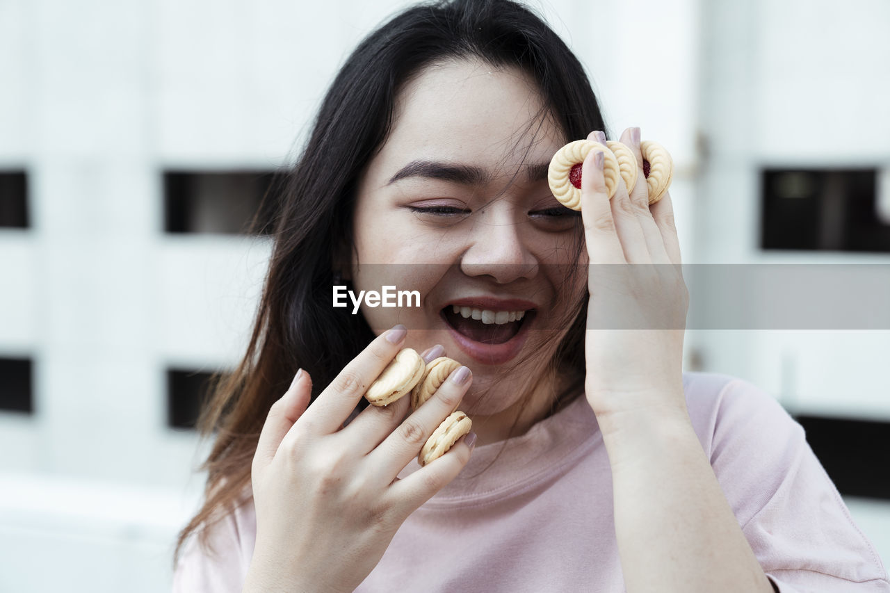 Portrait of smiling young woman with eyes closed