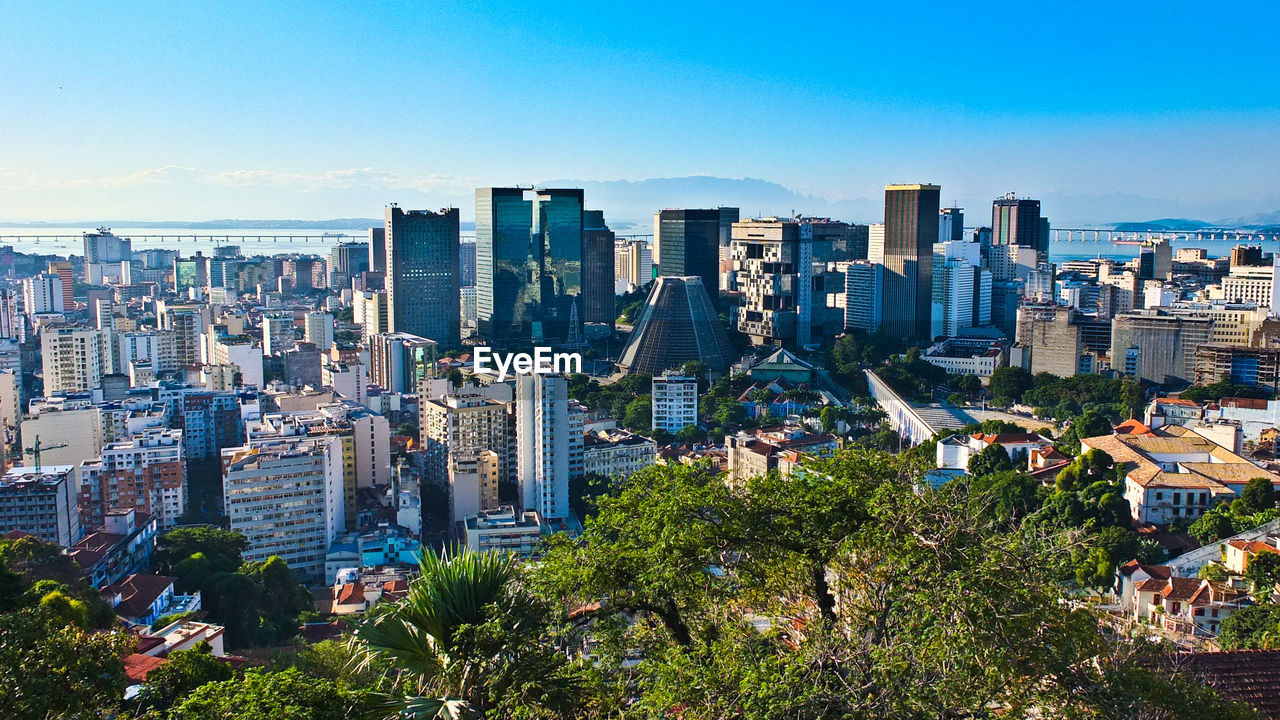 View of cityscape against blue sky