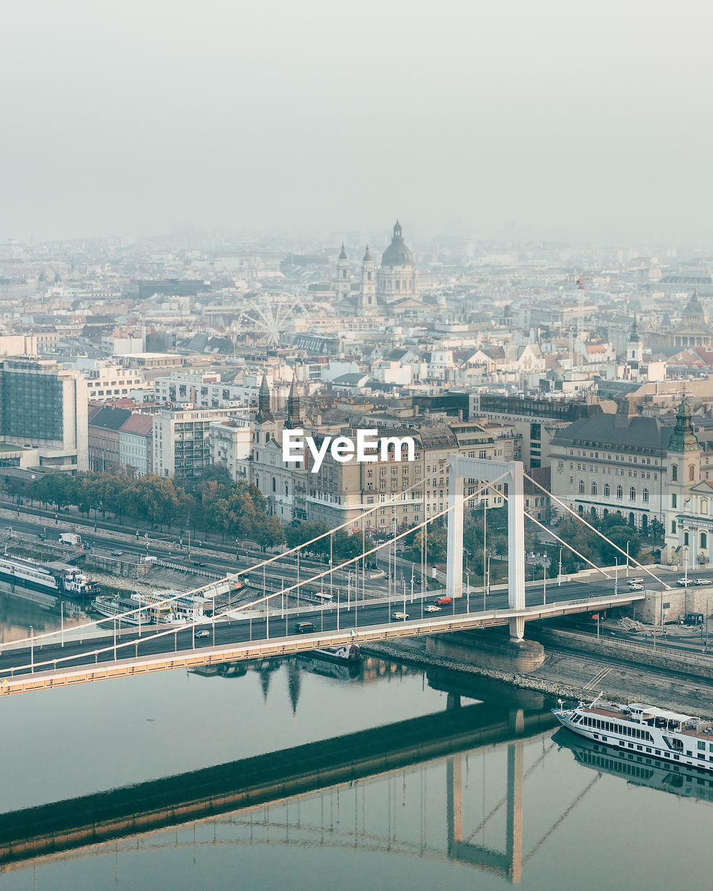 Aerial view of bridge over river and buildings in city