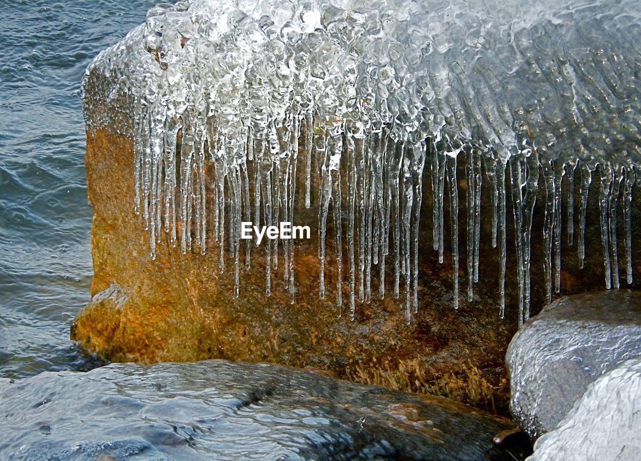 High angle view of frozen rock in lake