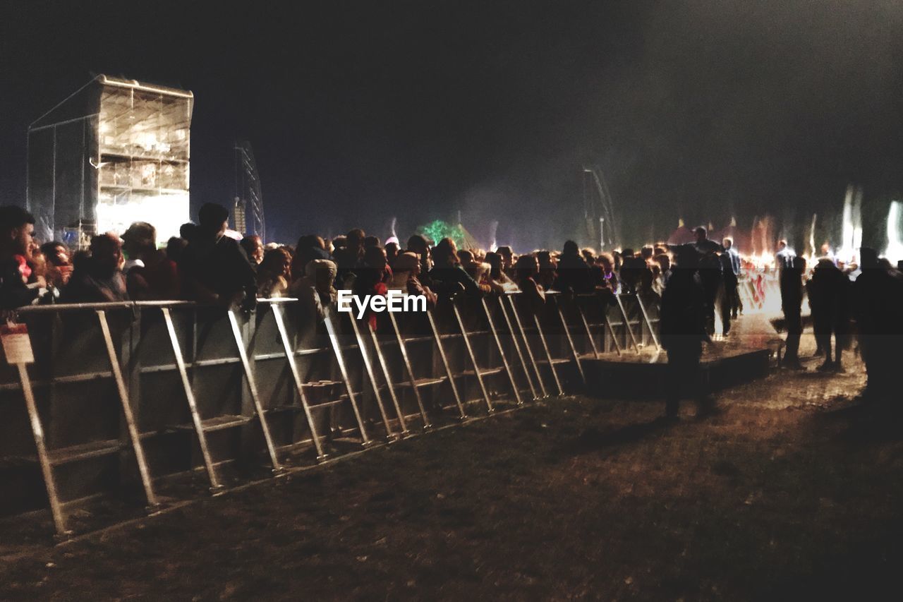 GROUP OF PEOPLE AT MUSIC CONCERT