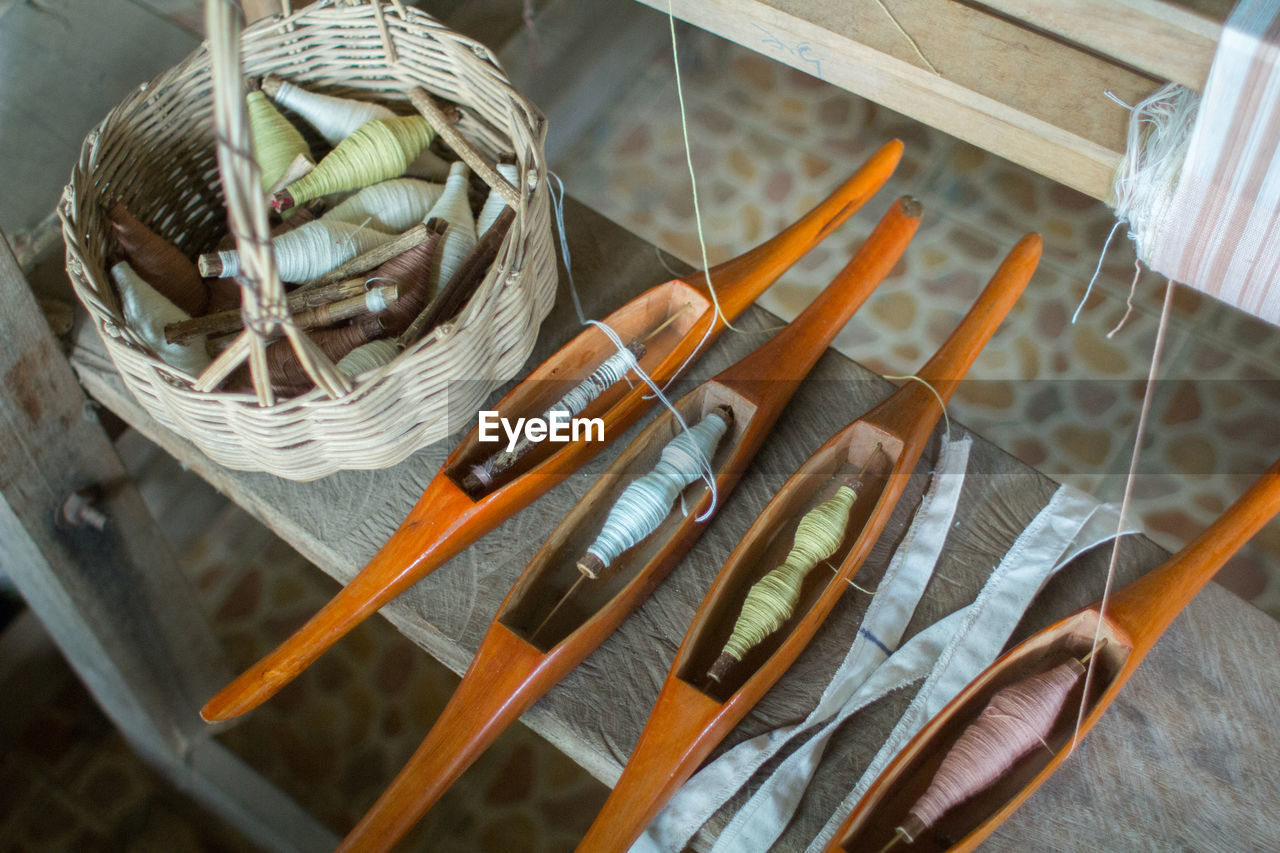 HIGH ANGLE VIEW OF WICKER BASKET IN GLASS TABLE