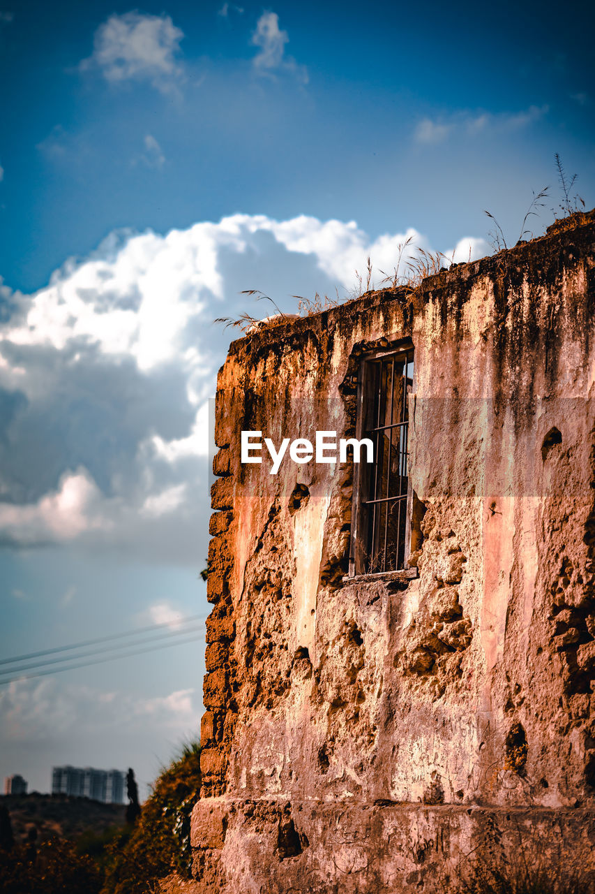 sky, cloud, architecture, nature, built structure, rock, building exterior, building, no people, history, travel destinations, travel, wall, outdoors, old, the past, city, landscape, evening, land, reflection, house, environment, sunset, blue, ancient history, sunlight