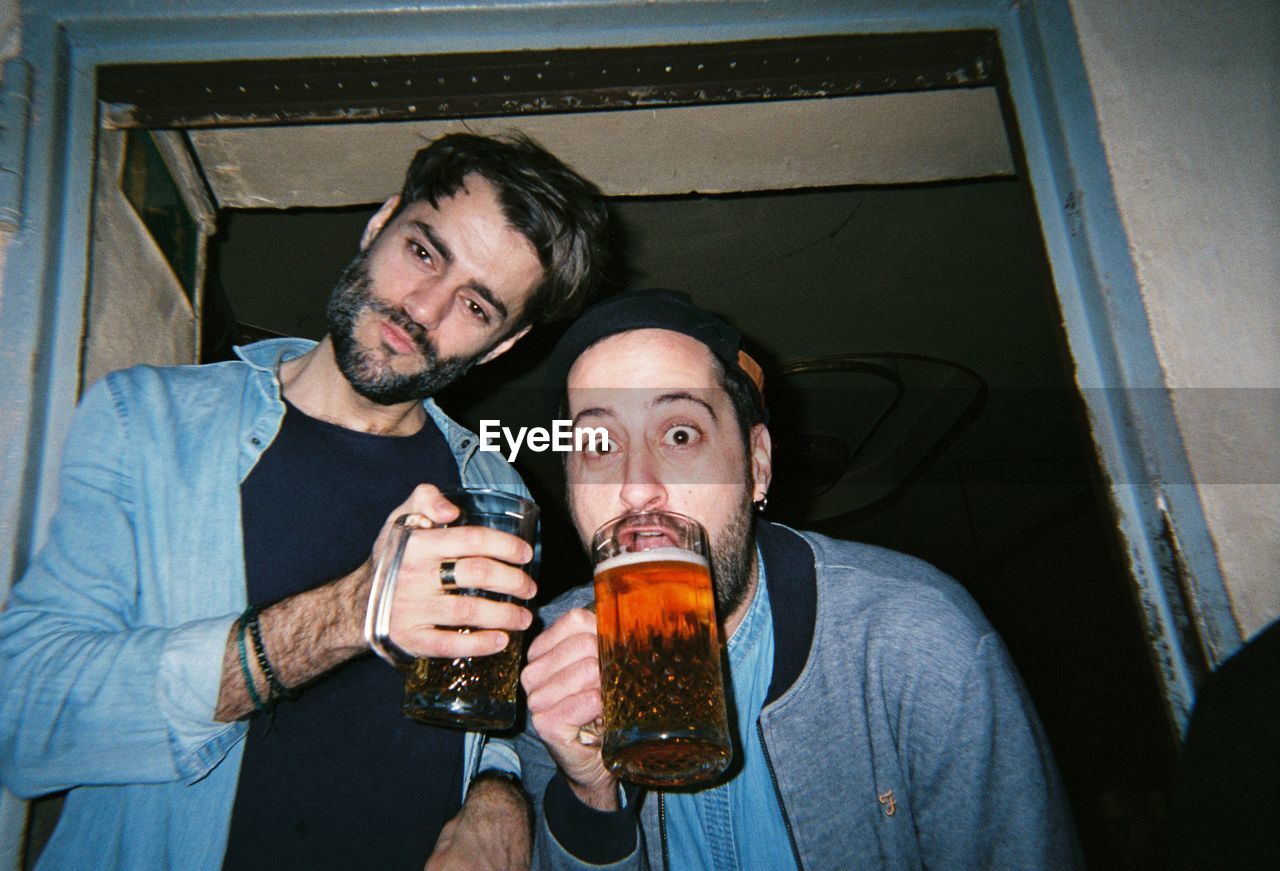 PORTRAIT OF A MAN DRINKING GLASS WITH BEER IN GLASSES