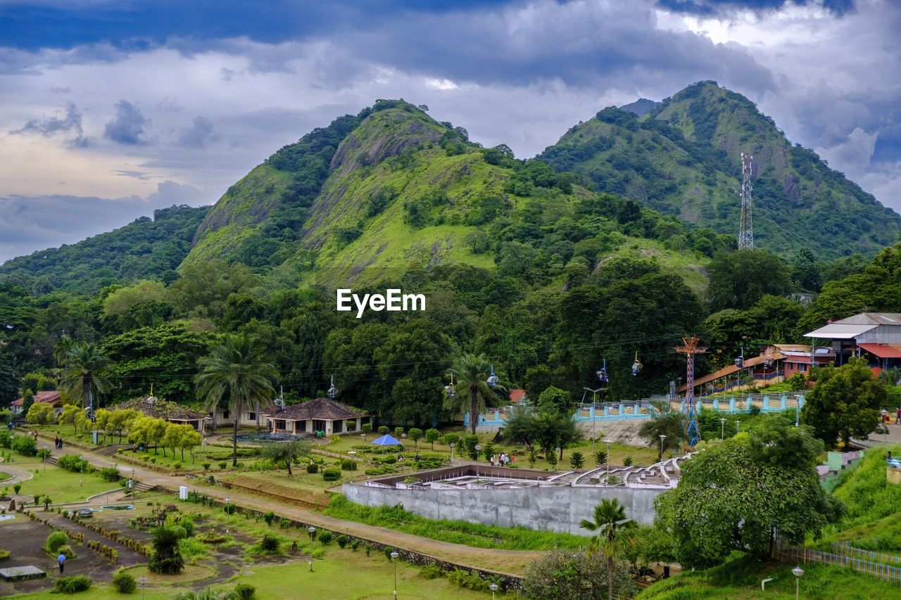 Scenic view of park with a cable car and hills against the sky