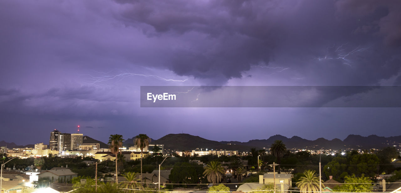 LIGHTNING OVER ILLUMINATED BUILDINGS IN CITY