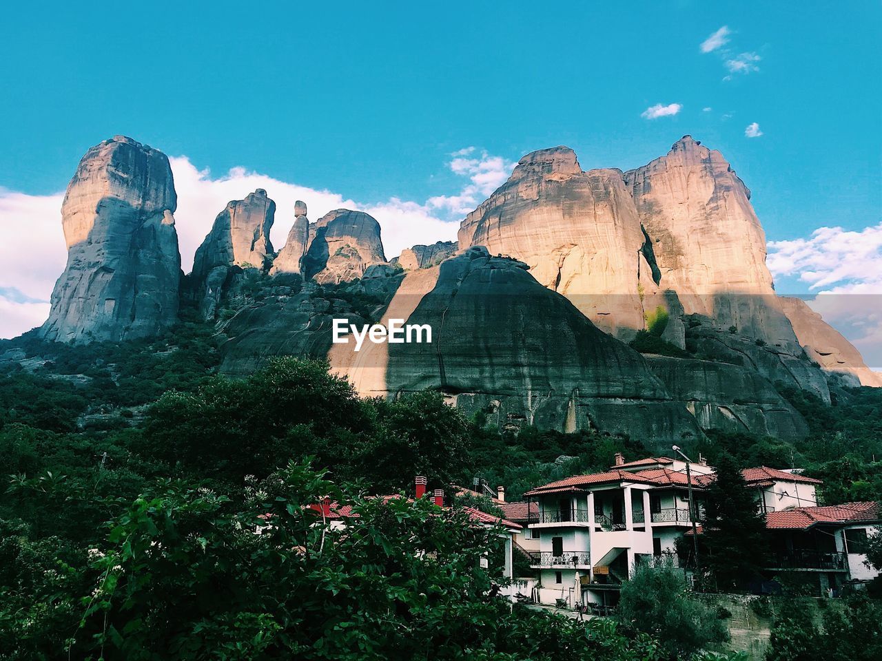 Panoramic view of buildings and mountain against sky