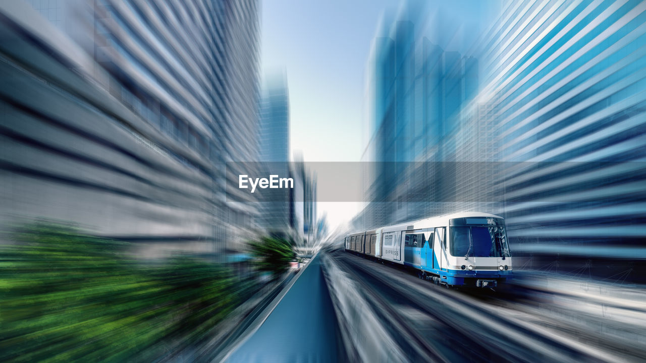 BLURRED MOTION OF TRAIN ON CITY