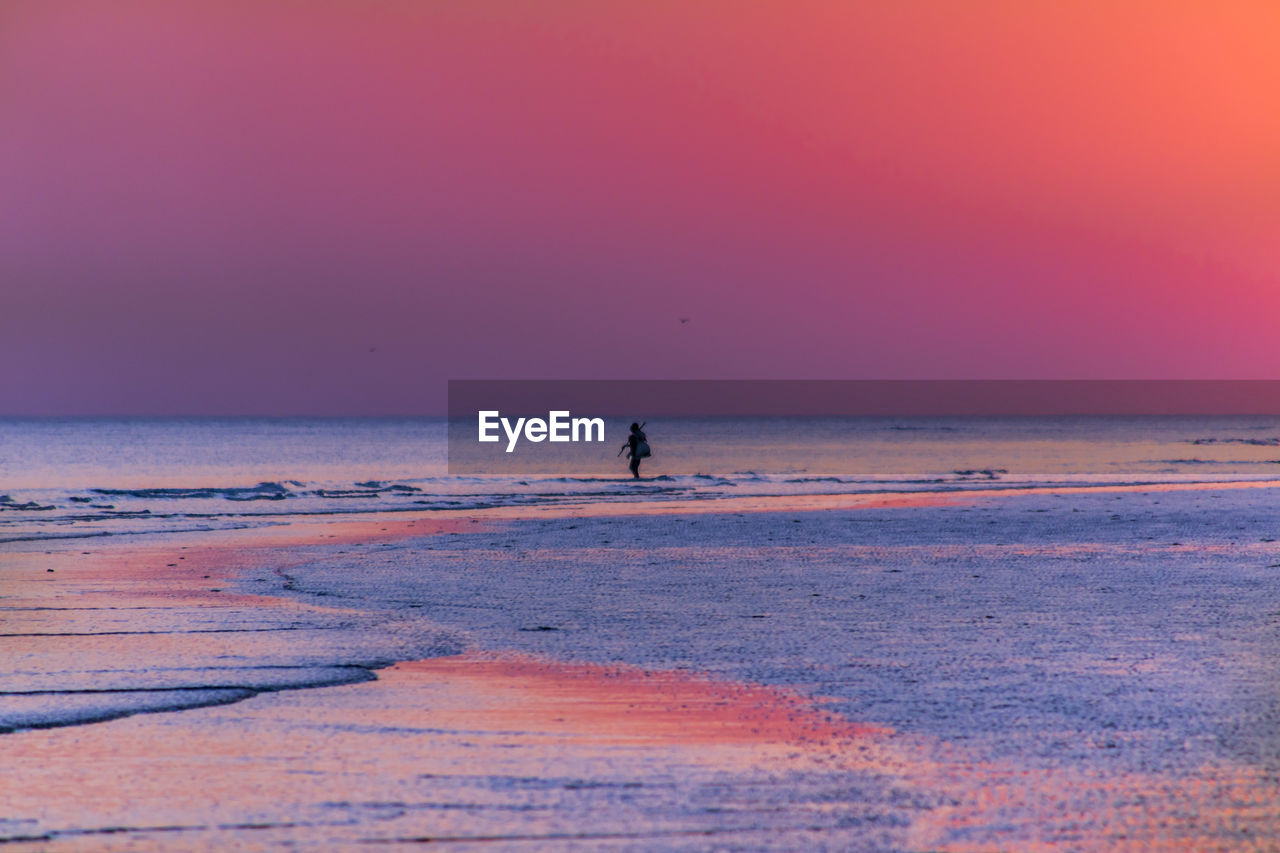 SCENIC VIEW OF BEACH DURING SUNSET