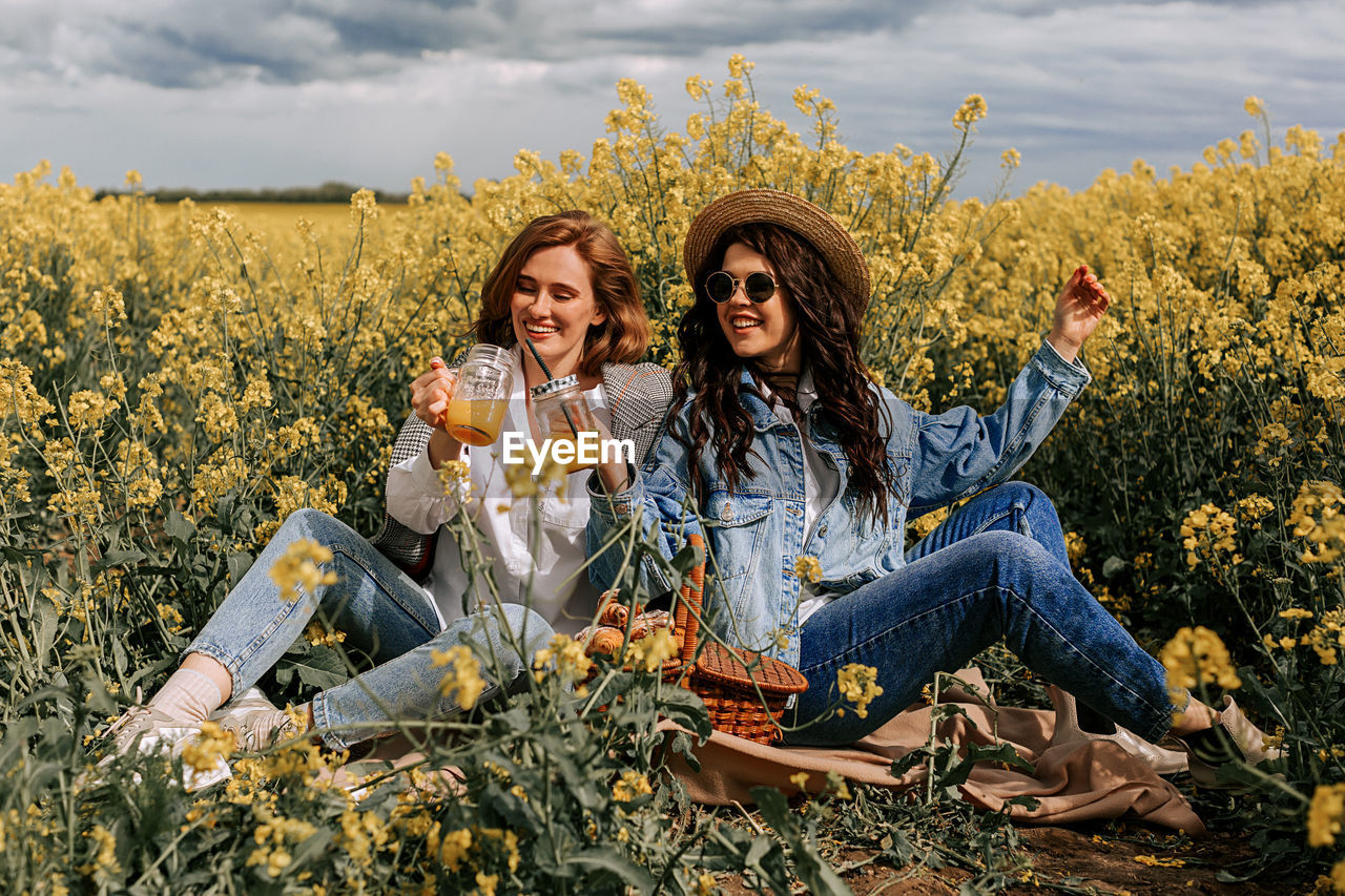 Flowers in a field with beautiful girls. huge selection of tulips and rapeseed