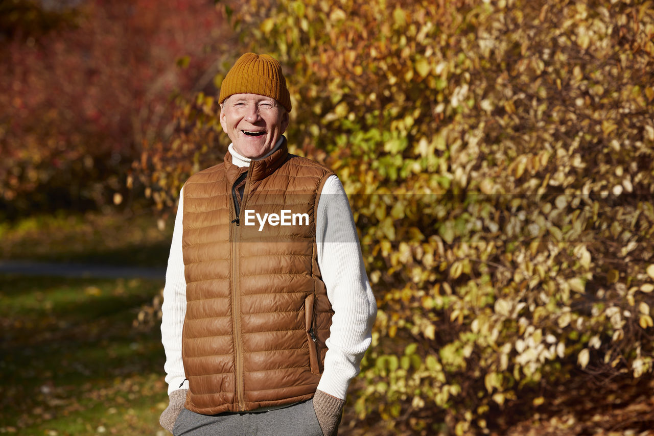 Portrait of senior man in autumn scenery