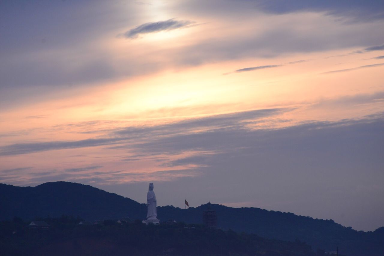 SCENIC VIEW OF MOUNTAINS AT SUNSET