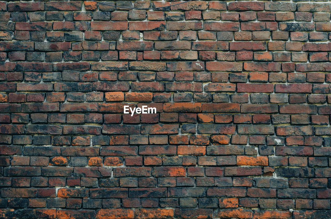 Vintage dark brick wall. brickwork with cracks. abstract background.