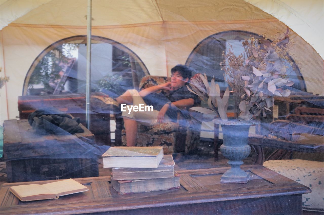 PEOPLE SITTING BY WINDOW