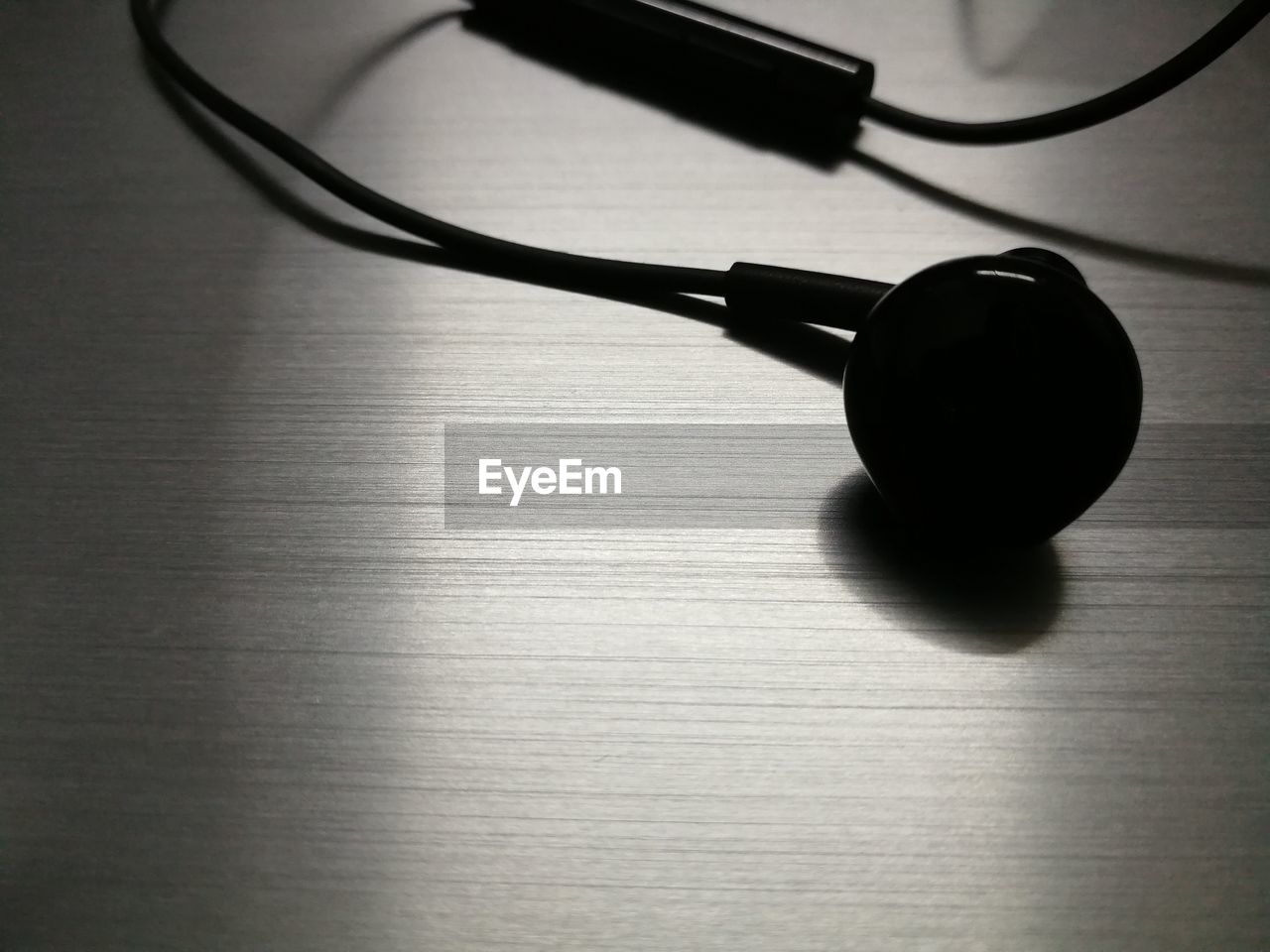 High angle view of black earphones on table