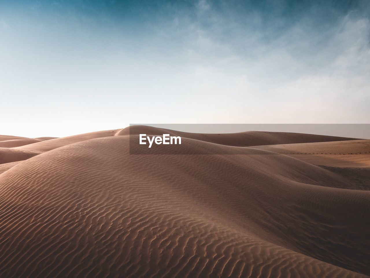 Sand dunes in the desert during the day