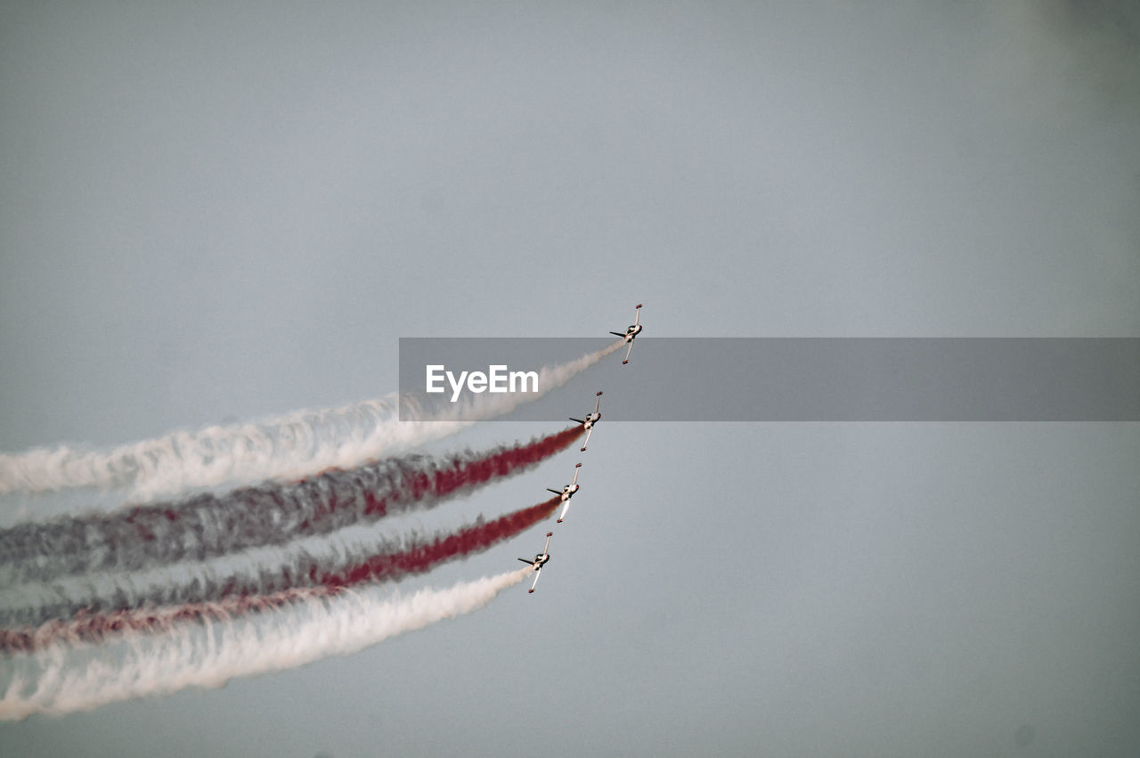 Low angle view of airplane flying against sky