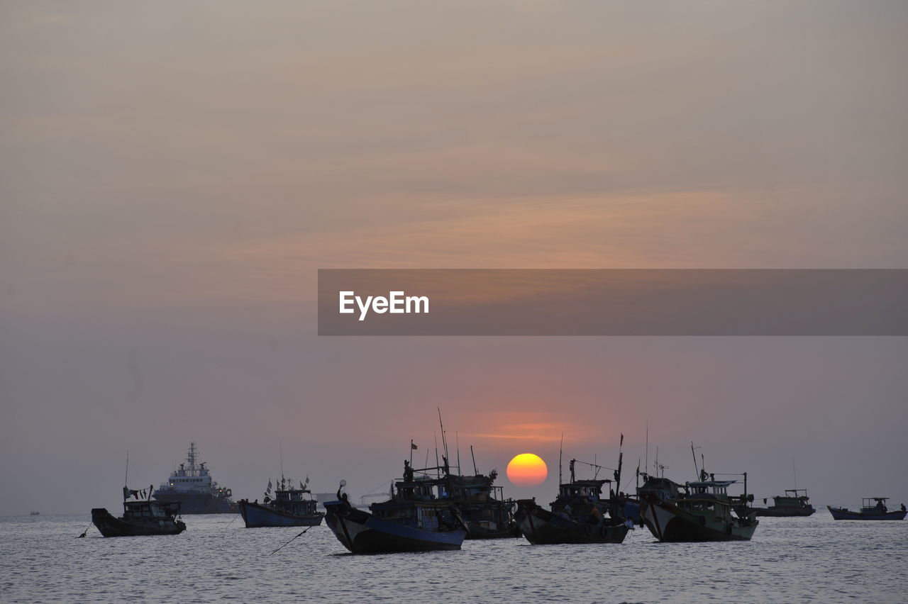 BOATS IN SEA AGAINST SKY DURING SUNSET