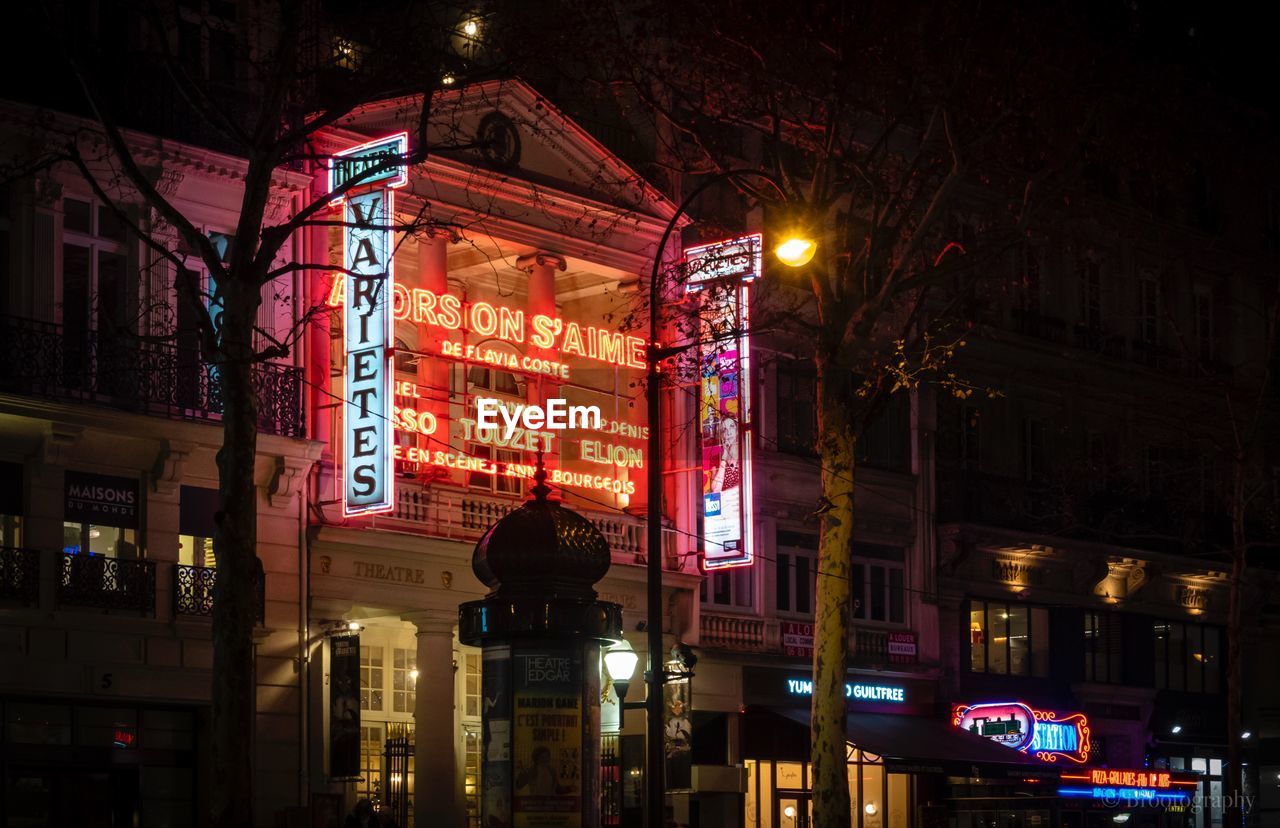 ILLUMINATED BUILDING AT NIGHT IN CITY