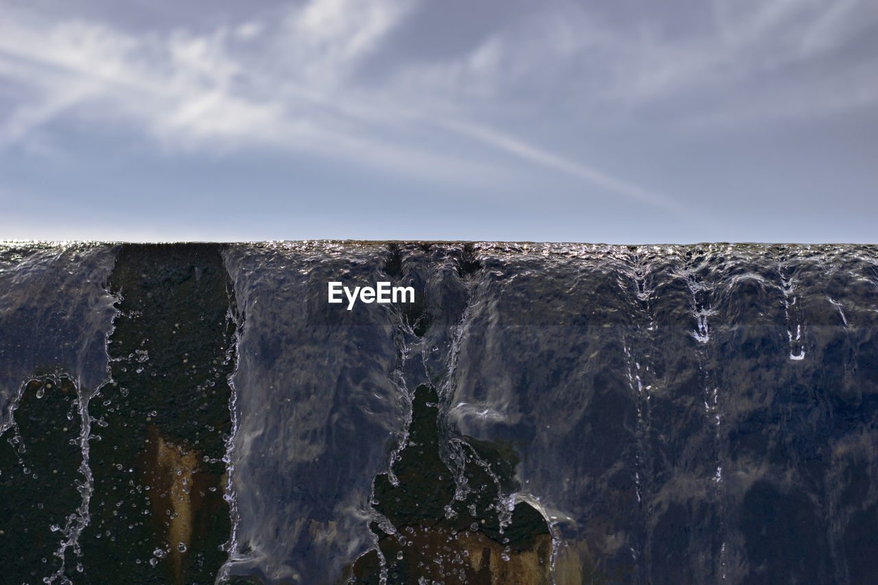 Panoramic view of waterfall against sky