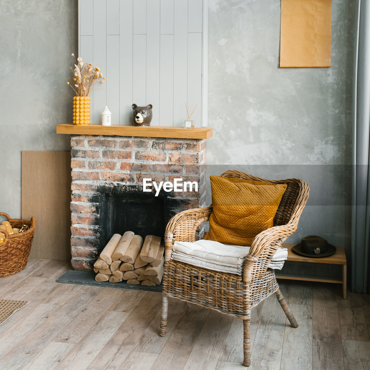 The interior of the living room in a country house. cozy fireplace and wicker chair