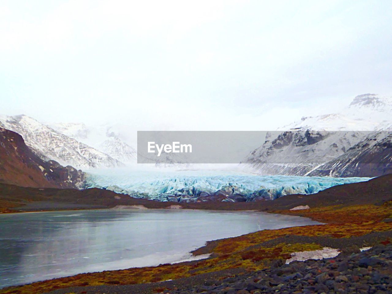 SCENIC VIEW OF LAKE AGAINST MOUNTAIN RANGE