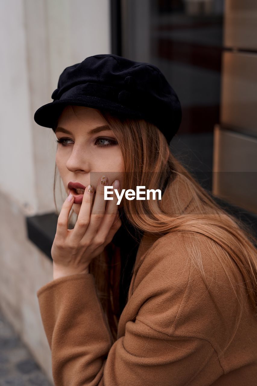 Thoughtful young woman looking away in city