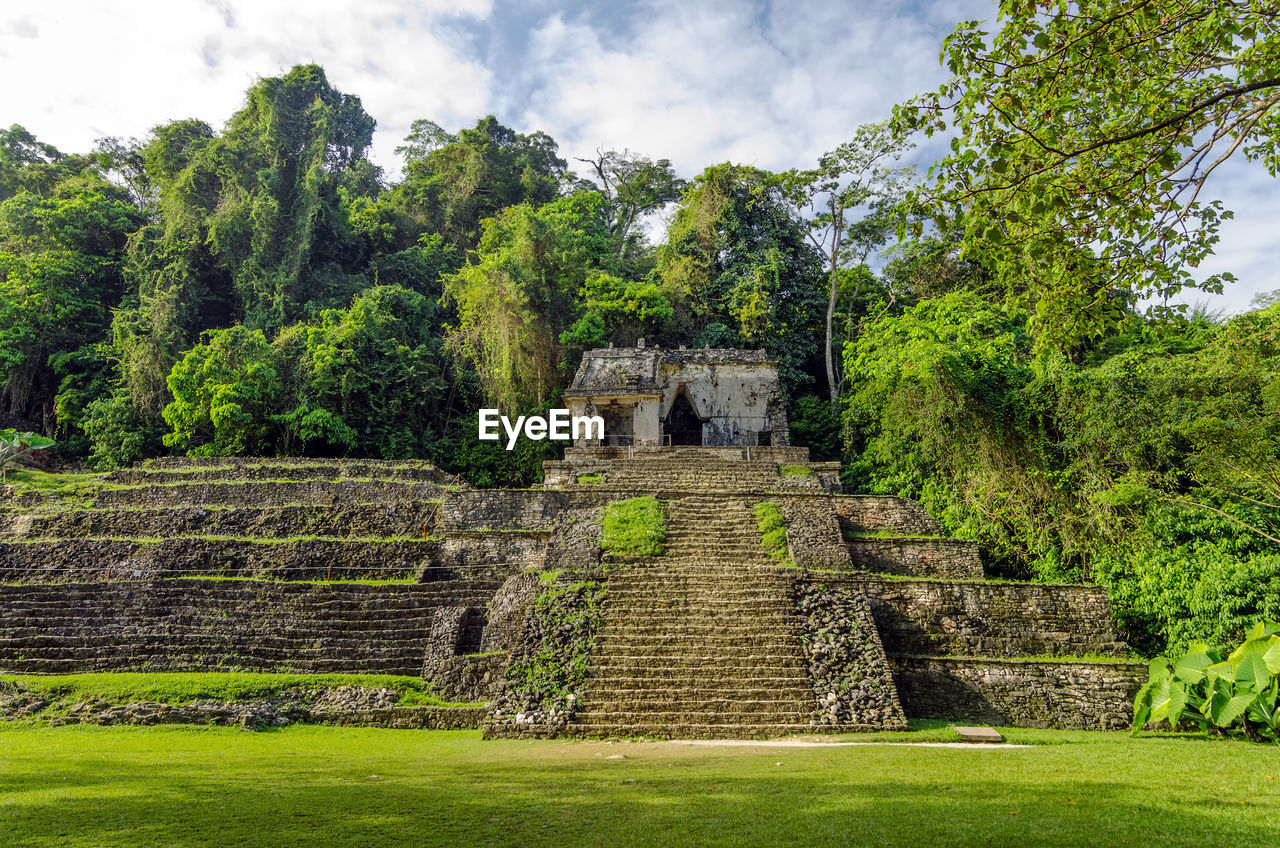 Exterior of historic temple against trees