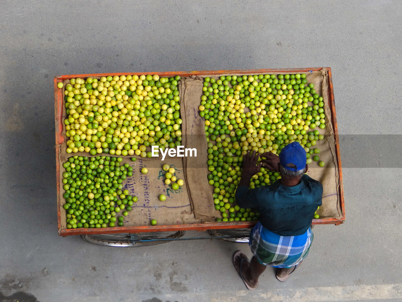 High angle view of man selling lemons 