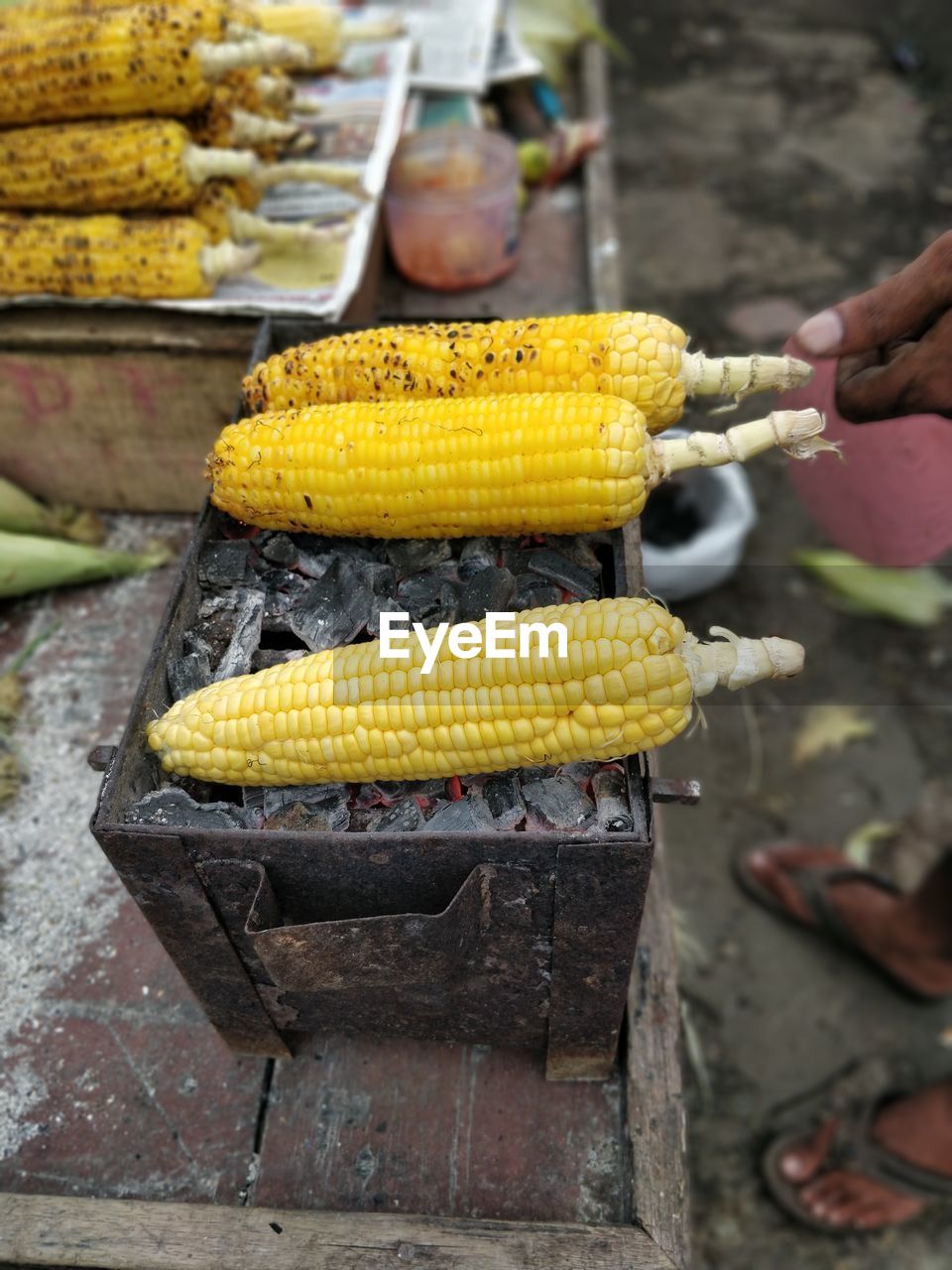 High angle view of yellow corn on bbq for sale in market