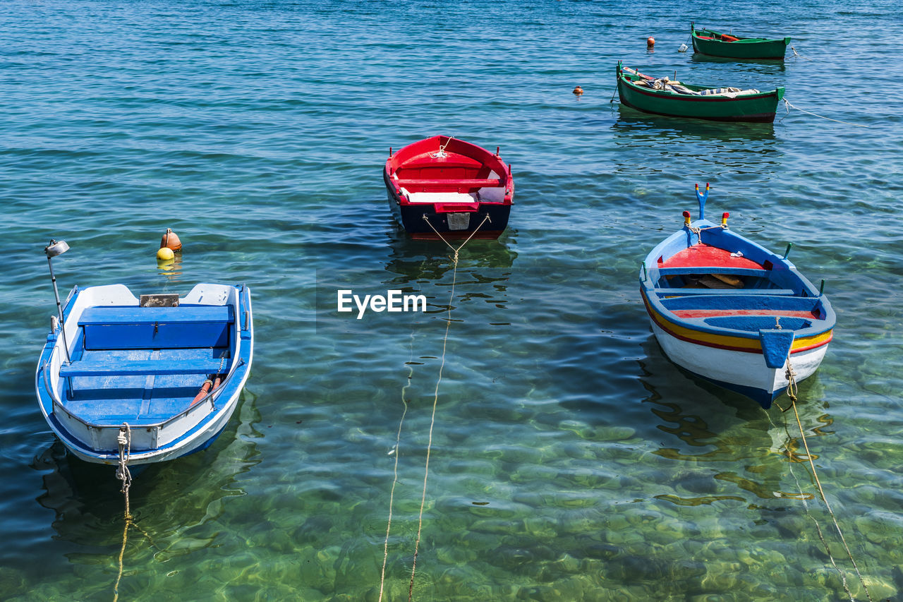 HIGH ANGLE VIEW OF MOORED IN SEA