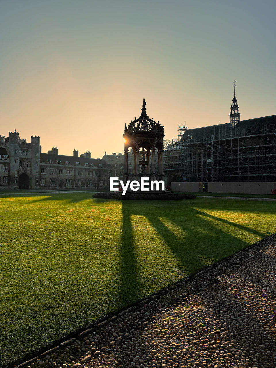 architecture, morning, built structure, sky, travel destinations, building exterior, city, history, the past, grass, nature, travel, horizon, sunlight, reflection, tourism, dusk, building, cityscape, landmark, urban area, skyline, outdoors, no people, clear sky, sculpture, château, landscape, memorial, tree, plant, lawn