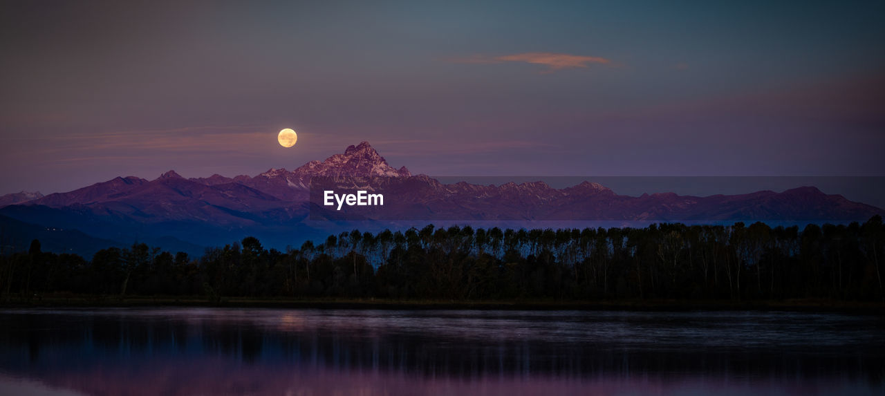 Lunar sunset behind the mountain in italy