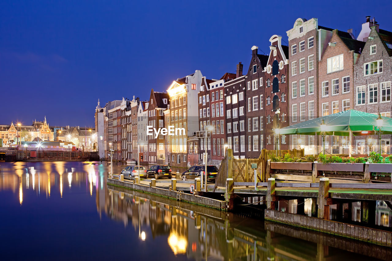 Canal passing through city at night