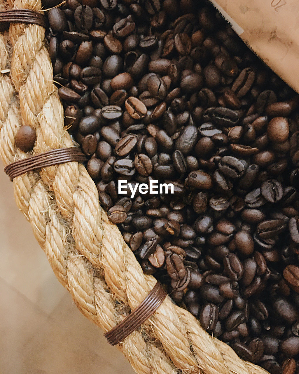 HIGH ANGLE VIEW OF COFFEE BEANS IN WICKER BASKET